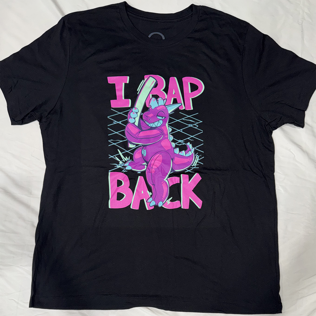 Black screen printed t-shirt with the design of a pooltoy dragon with matching text, "I BAP BACK," in the background.