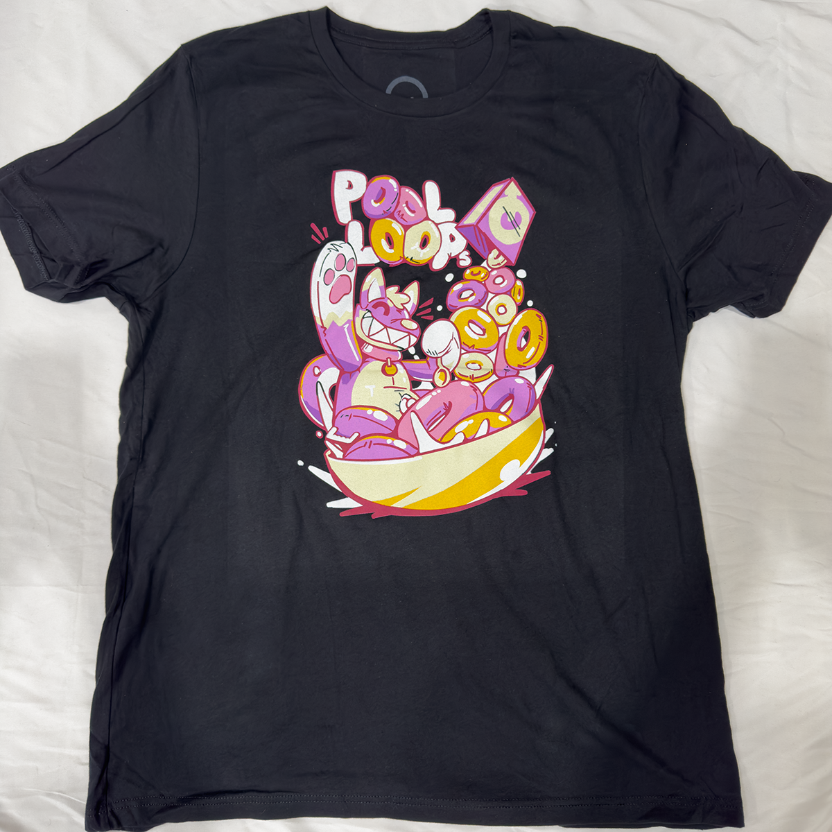 Black screen print t-shirt featuring a pooltoy dog inside of a cereal bowl with the text, "Pool Loops," in the background.